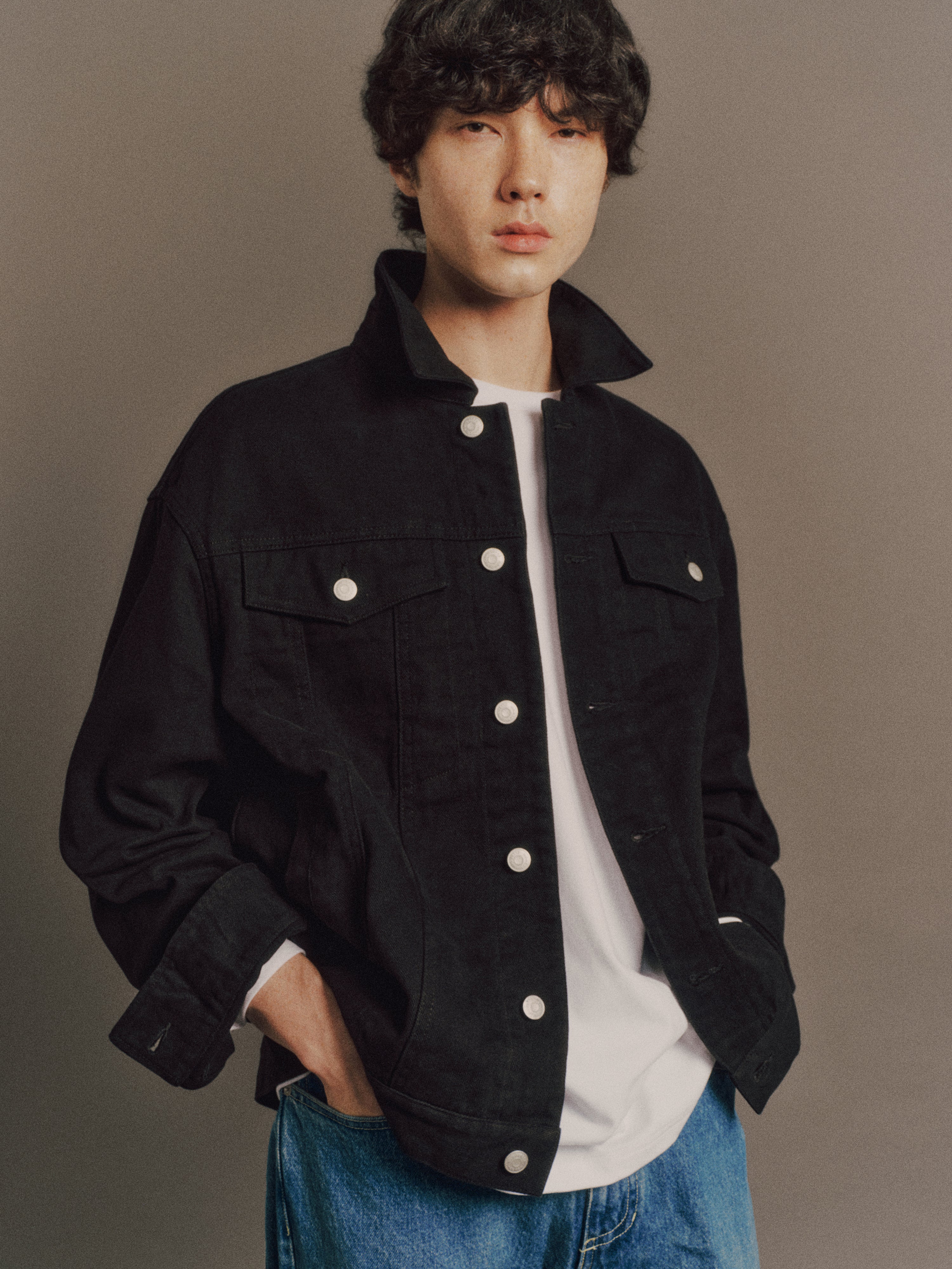 Émile wears Noel Jacket in Black, Denzel 
Top in White